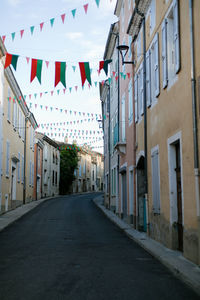 Street amidst houses and buildings in city