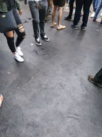 Low section of people walking on street