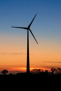 Silhouette windmill against sky during sunset