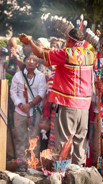 Rear view of man standing in front of crowd during festival