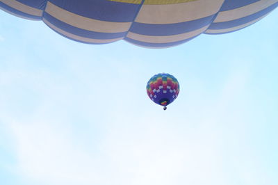 Low angle view of hot air balloon against blue sky