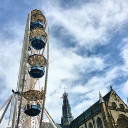 Low angle view of clock tower against cloudy sky