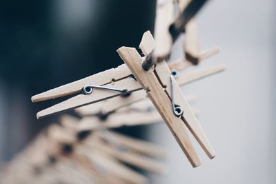 Close-up of clothespins on rope outdoors