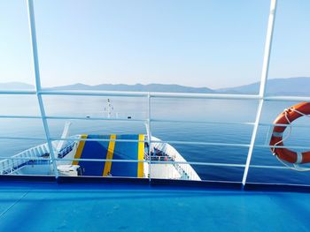 Sailboat sailing on sea against clear blue sky