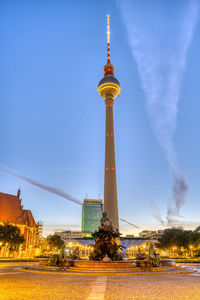 The famous berliner fernsehturm with the neptune fountain before sunrise