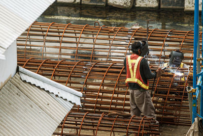 Rear view of man working at construction site