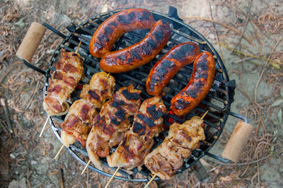 High angle view of meat on barbecue grill