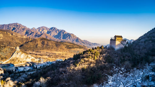 Scenic view of snowcapped mountains against clear blue sky