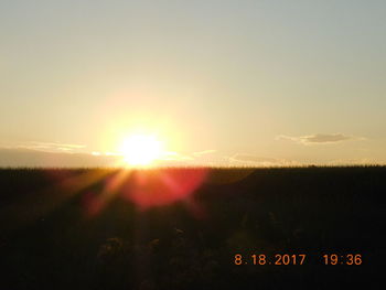 Scenic view of field against sky during sunset