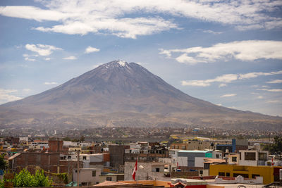 Town by mountains against sky