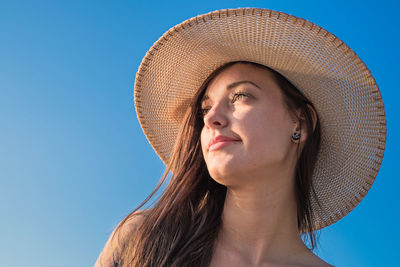 Woman wearing sun hat against clear sky