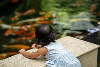 Rear view of girl standing outdoors