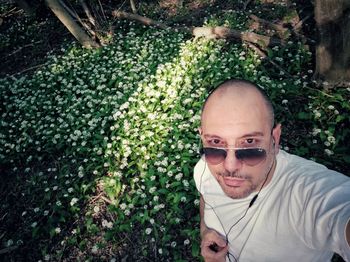 Portrait of man wearing sunglasses against plants