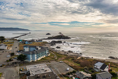 High angle view of townscape by sea against sky during sunset