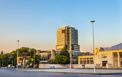 City street and buildings against clear sky