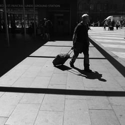 People walking on sidewalk in city