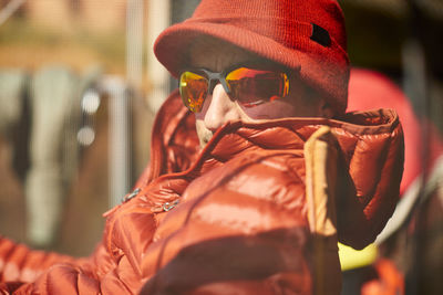 An outdoor portrait of a man in red.