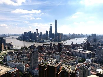 Aerial view of buildings in city against sky