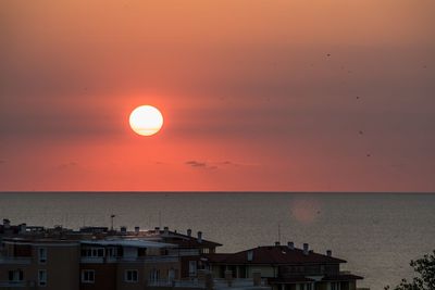 Scenic view of sea against orange sky