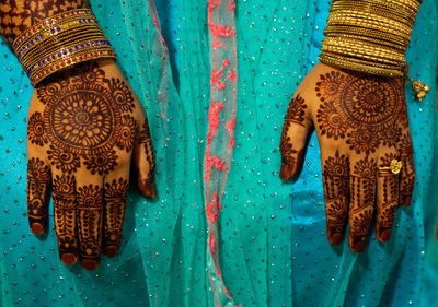 Close-up of woman on blue umbrella