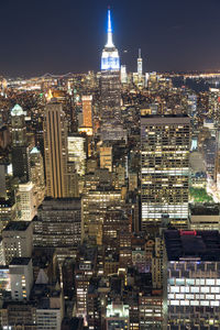 High angle view of illuminated buildings in city at night