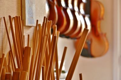 Close-up of wooden sticks with violins in background at store