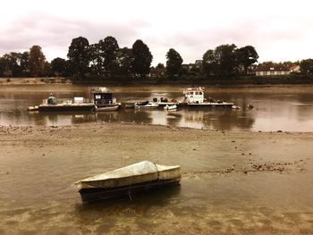 Boats moored in river