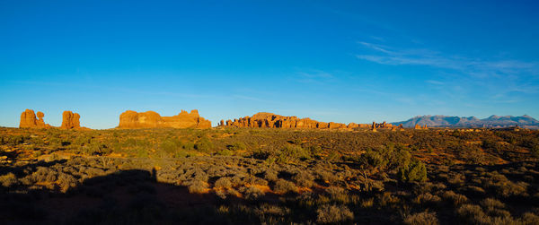 Scenic view of rocky landscape against blue sky