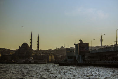 The new mosque and galata bridge at sunset in istanbul 