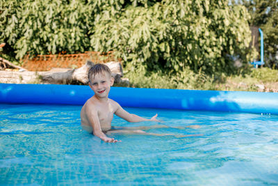 Portrait of smiling boy swimming in pool