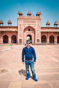 Full length portrait of man standing against sky