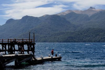 Scenic view of sea and mountains against sky