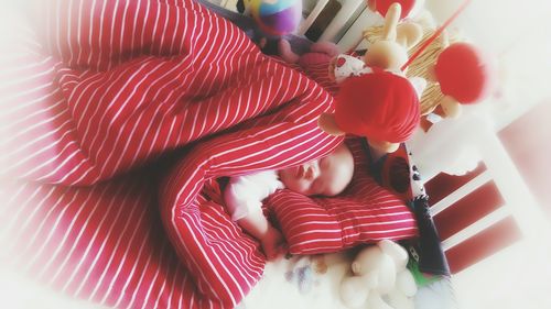 High angle view of baby boy sleeping in crib at home