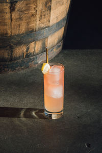 Pink lemonade on concrete floor in front of whiskey barrel