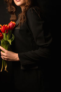 Midsection of woman holding bouquet