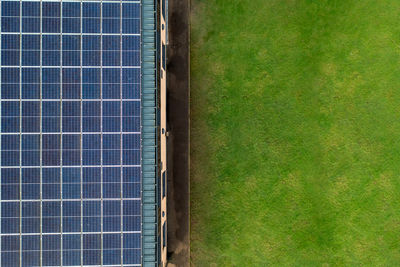 High angle view of solar panel and grass on environmentally friendly house