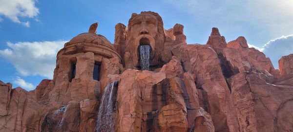 Low angle view of rock formation against sky