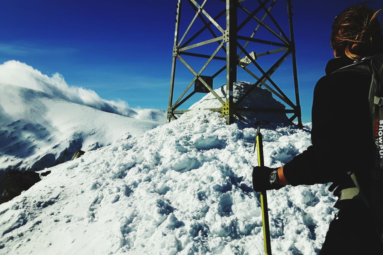 snow, winter, cold temperature, real people, leisure activity, lifestyles, one person, sky, nature, warm clothing, day, scenics - nature, clothing, mountain, standing, men, white color, beauty in nature, outdoors, snowcapped mountain, extreme weather