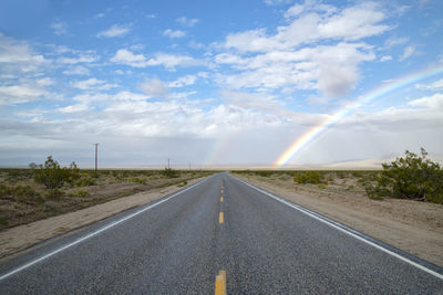 Mojave desert highway with rainbow