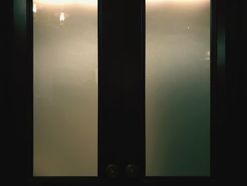 Silhouette of building seen through glass window