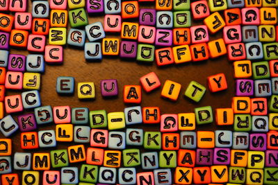 Directly above shot of multi colored letter blocks on table