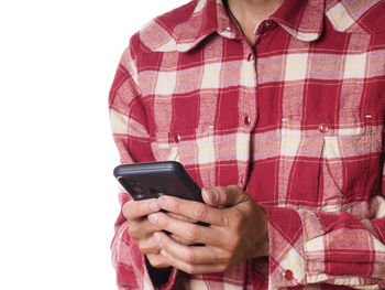 Midsection of man using mobile phone against white background