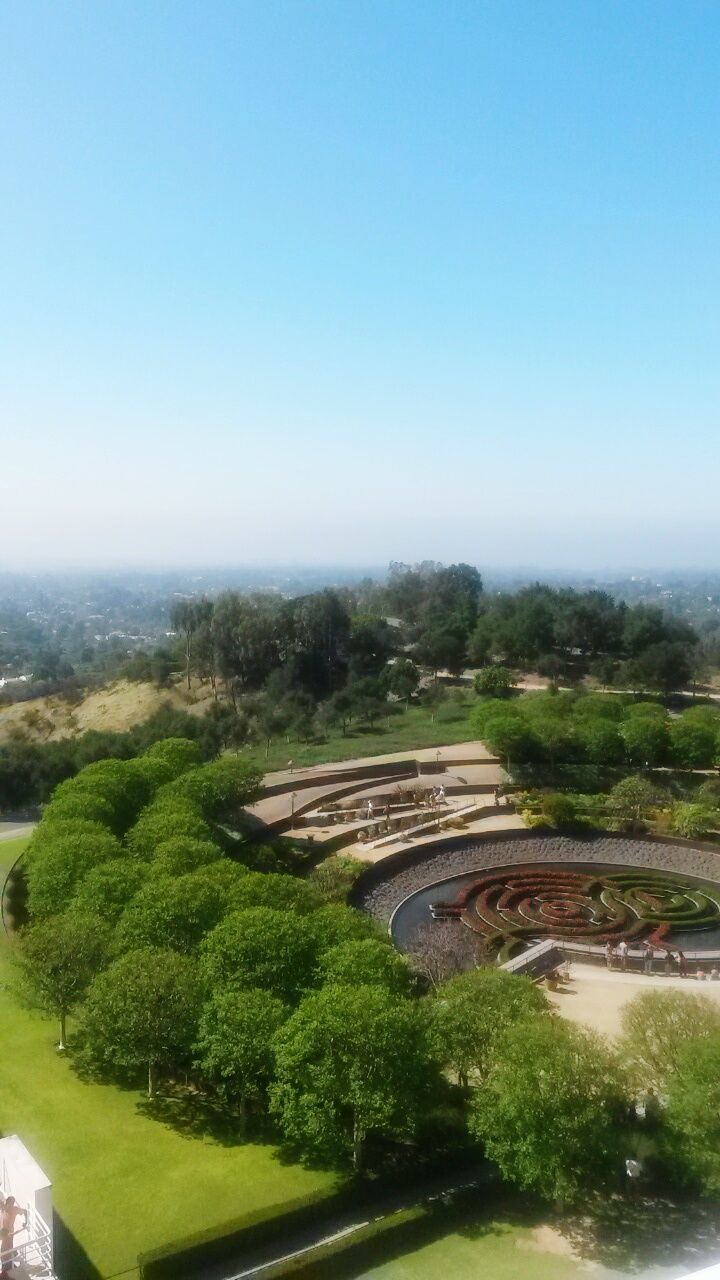 clear sky, tree, water, built structure, copy space, architecture, high angle view, green color, nature, tranquility, landscape, tranquil scene, day, scenics, river, outdoors, beauty in nature, no people, growth, building exterior