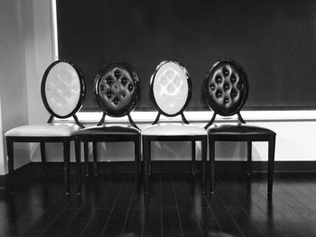 Close-up of chairs on table at home