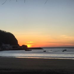 Scenic view of sea against clear sky during sunset