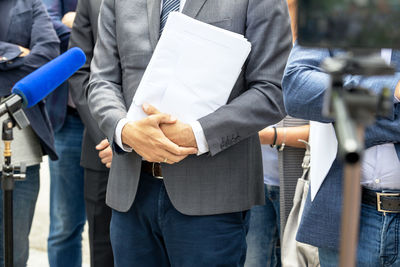 Rear view of people standing on paper