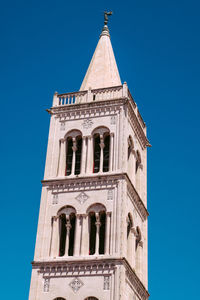 Low angle view of clock tower against clear sky