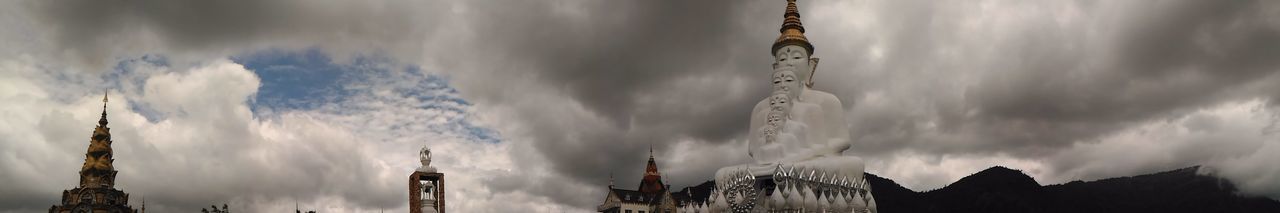 Low angle view of building against cloudy sky