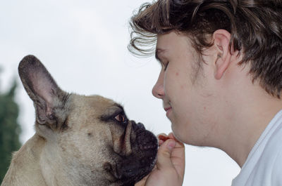Close-up of teenage boy with dog