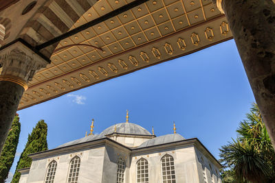 Low angle view of buildings against clear blue sky